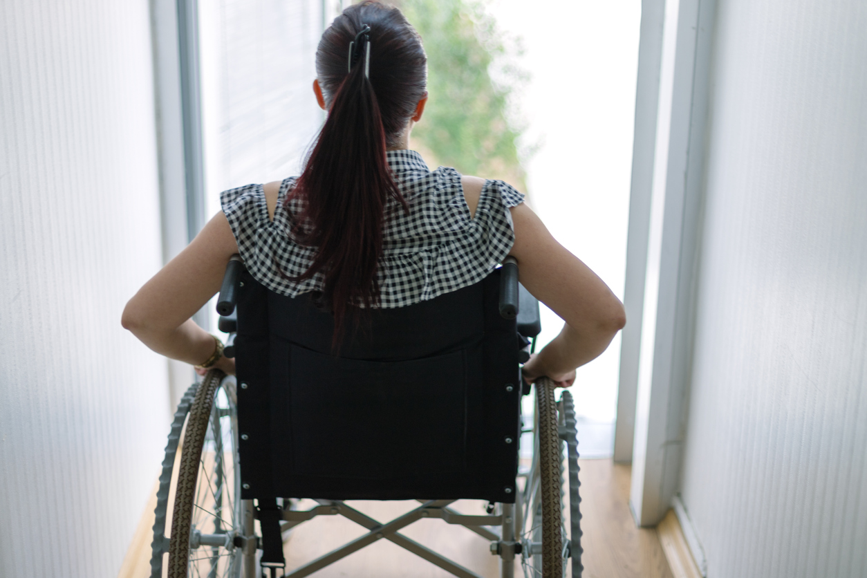 Thoughtful businesswoman in a wheelchair at work