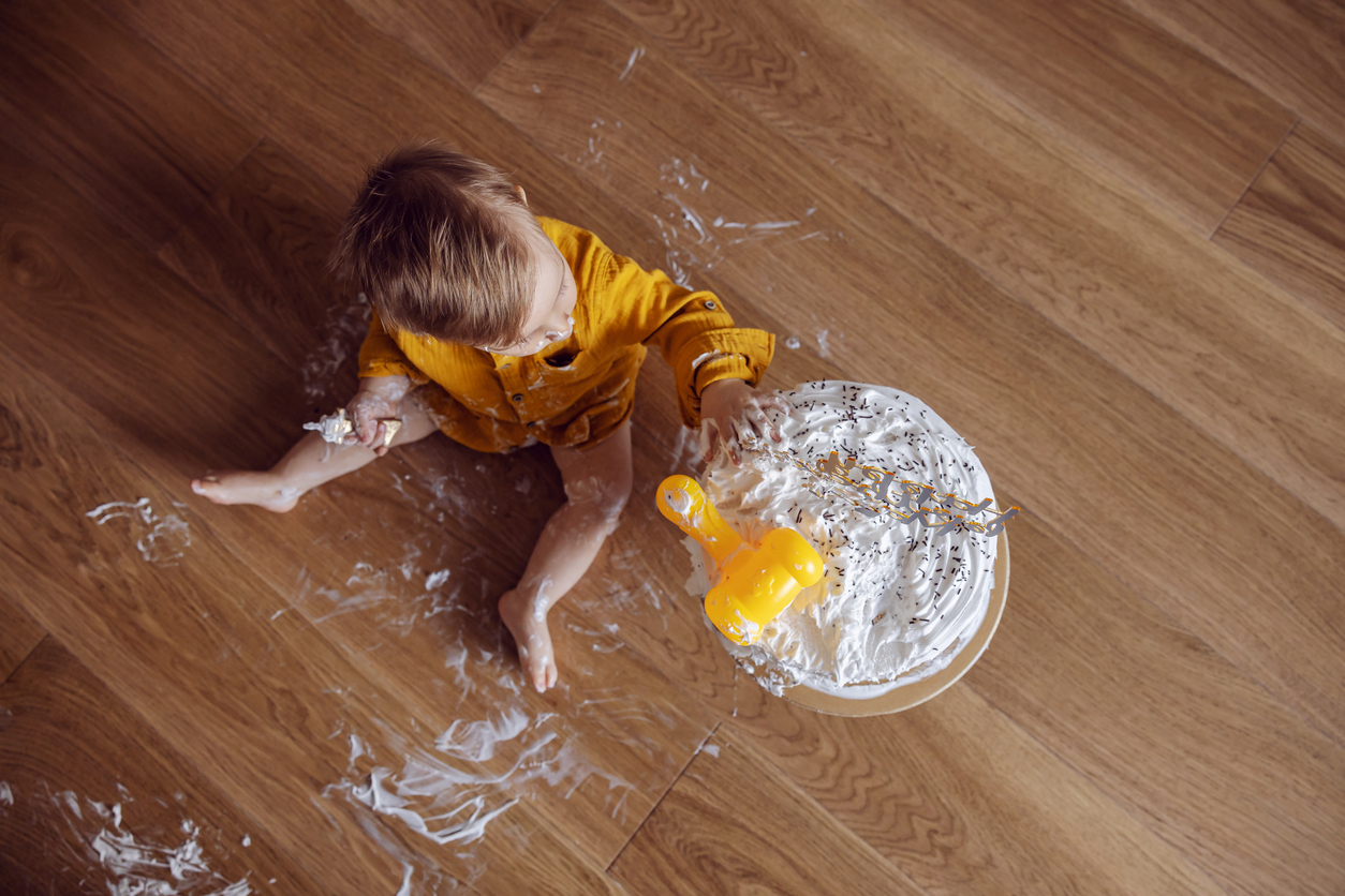 Toddler playing with cake