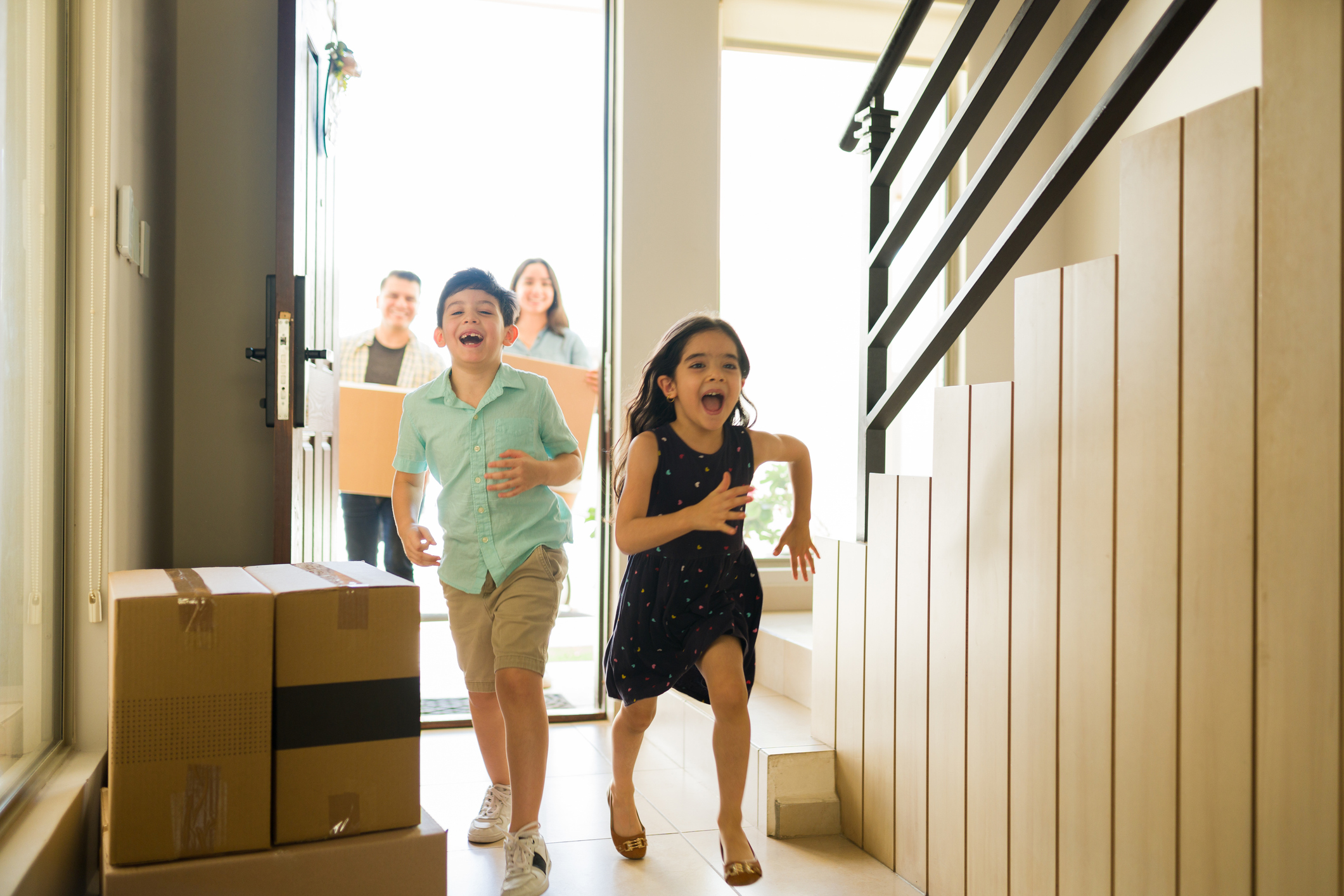 Excited kids moving in and laughing while running in their new home