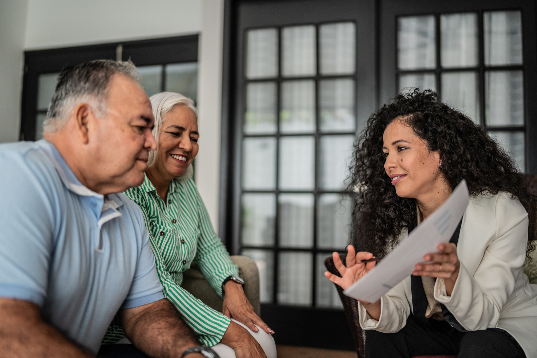 Financial advisor having a meeting with senior couple at home